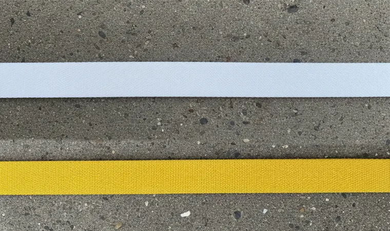 Side by side comparison of Yellow Kevlar Aramid webbing and White Dyneema UHMWPE webbing.